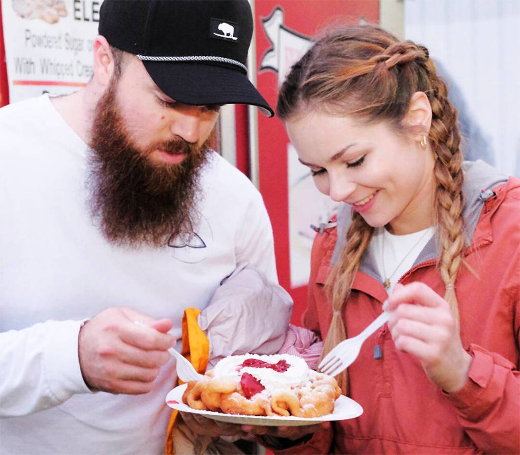 Rain or shine funnel cake always tastes good as Ty Brewen and Megan Drinnon can attest.