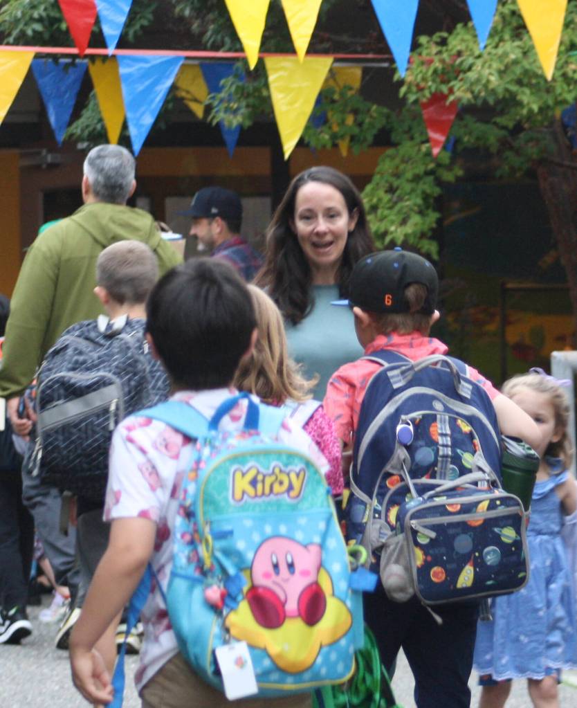 Ordway students are greeted by their teacher on the first day of school.