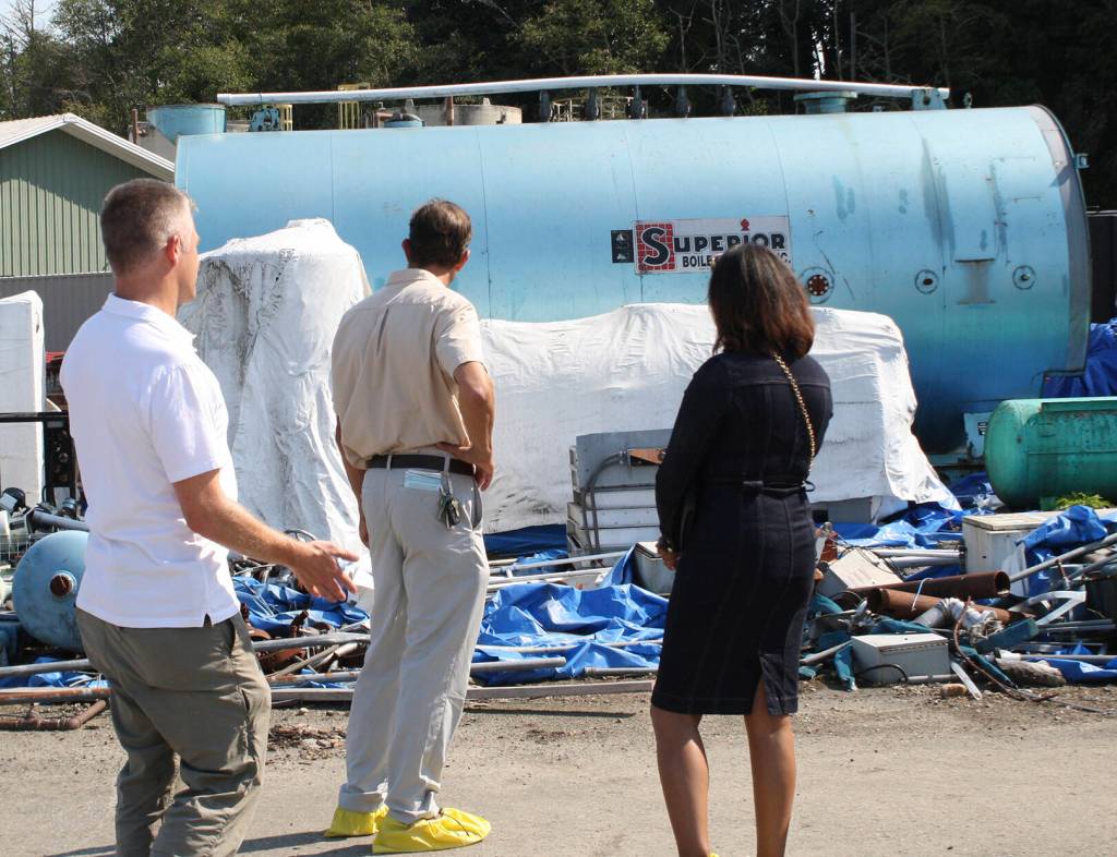 Officials look over debris left over from prior cleanup operations at Wyckoff.