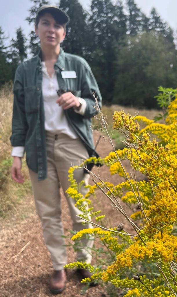 Kaslin Daniels points out a native goldenrod prior to the controlled burn.