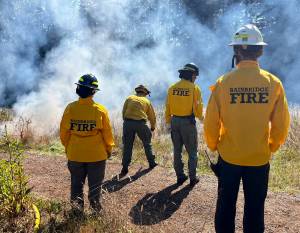 Molly Hetherwick/Kitsap News Group photos
Bainbridge Fire Department personnel monitor a flame.