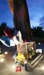 Kitsap 9/11 Facebook courtesy photo
Flowers and notes surround the beams from the Twin Towers in New York that were made into a memorial in Bremerton Sept. 11.