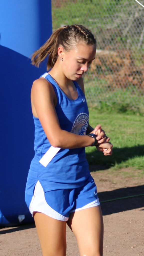 Olympics Brynn Fulton does a time check after crossing the finish line.