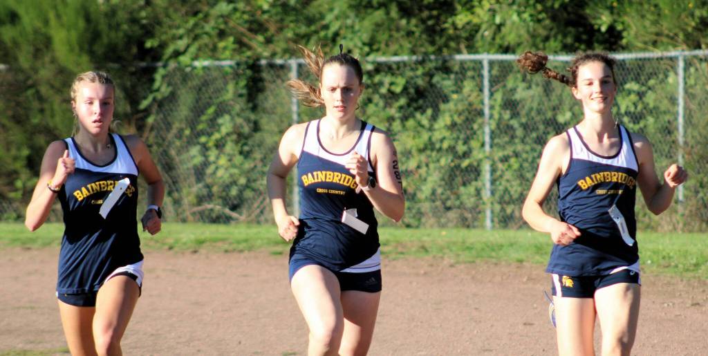 Bainbridges trio of runners Mairin OBrien, Sabine Hartenstine and Evelyn Shutske lead the way in the 2A Olympic League opener.