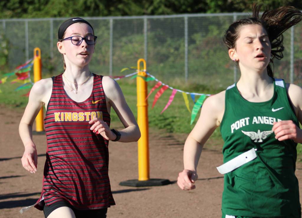 Kingston sophomore Emma Grice hangs with a Port Angeles runner in the 2A Olympic League opener.