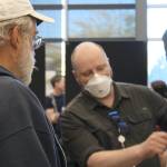 Senior city planner Peter Best, with mask, explains some information to BI residents.