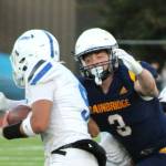 Elisha Meyer/Kitsap News Group photos
Bainbridge senior Adrian Ayling goes in for a tackle against a scrambling Olympic quarterback Antonio Castorena.