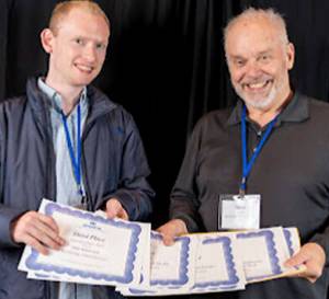 WNPA courtesy photo
Tyler Shuey and Steve Powell pick up the awards won by Bainbridge Island Review staff.