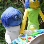 Pumpkin versions of Inside Out characters Sadness, left, and Joy stand at the helm of the emotions ship.