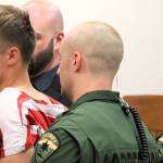 Elisha Meyer/Kitsap News Group
23-year-old double homicide suspect Seth South is restrained by shackles and a trio of correction officers in court Oct. 10. Officers began to accompany him before the judge after he made a sudden move toward the gallery of the courtroom.