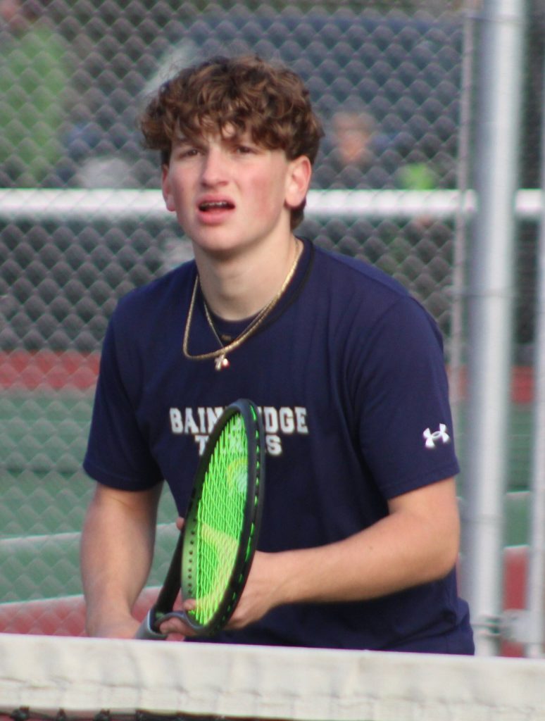 Bainbridges Topher Welch approaches the net right as a serve comes in from the opposite side.