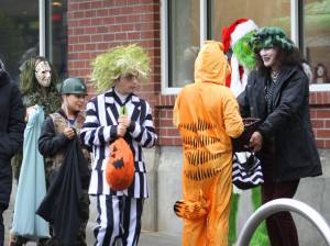 Molly Hetherwick/Kitsap News Group
Hometown Halloween was a big hit on Bainbridge Island Oct. 31, as always. Here, Beetlejuice and Garfield select some candy from a business owner along Winslow Way.