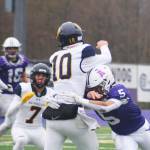 Bainbridge quarterback Nate Putnam (10) gets off a pass just as Miguel Maldonado (5) hits him.