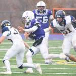 Carson Williams (32) tackles Anacortes quarterback Brady Beaner, with ball, with teammate junior Wyndham Kochenash (51) in hot pursuit.