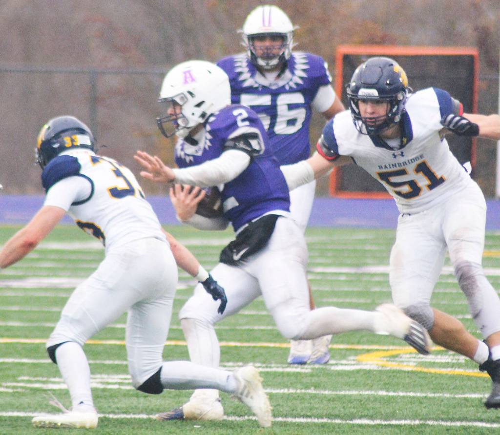 Carson Williams (32) tackles Anacortes quarterback Brady Beaner, with ball, with teammate junior Wyndham Kochenash (51) in hot pursuit.