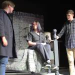 Greasers Darry (Liam Hayes, left), Ponyboy (Lily Terp, center) and Sodapop (Camden Diercks, right) discuss a friend suffering from an illness.