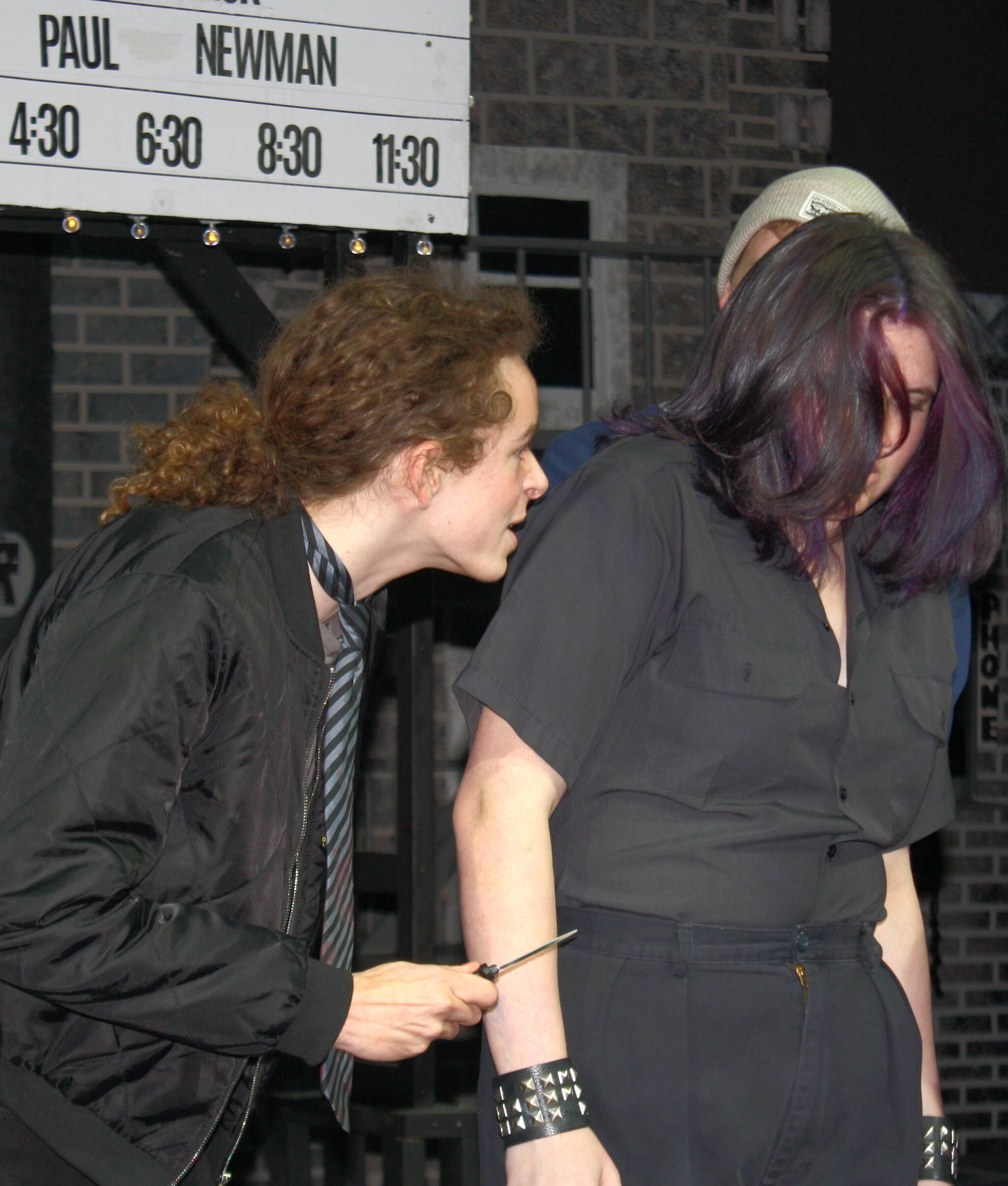 Preppy soc Bob (Otis Bowser, left) threatens working-class greaser Ponyboy (Lily Terp).