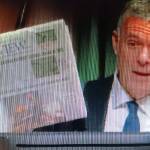 Steve Powell/Kitsap News Group
Bainbridge Mayor Joe Deets holds up the Review showing the top story is about the Highway 305-High School Road roundabout.