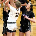 Bainbridge sophomore Anna Rowe goes up against two Issaquah defenders for a short jump shot from the blocks.