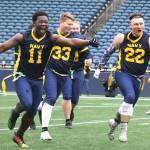 Defensive lineman and linebacker Mikah Graham (11) and linebacker Gage Pierson lead the sprint back to the Navy sideline after Armys late-game field goal attempt misses wide right.