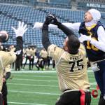 Navy defensive back Scott Drake helps break up an Army pass bound for the endzone.
