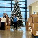 Britney Fletcher-West/Kitsap News Group photos
Volunteers stack boxes of donated toys to be given out at a local hospital.