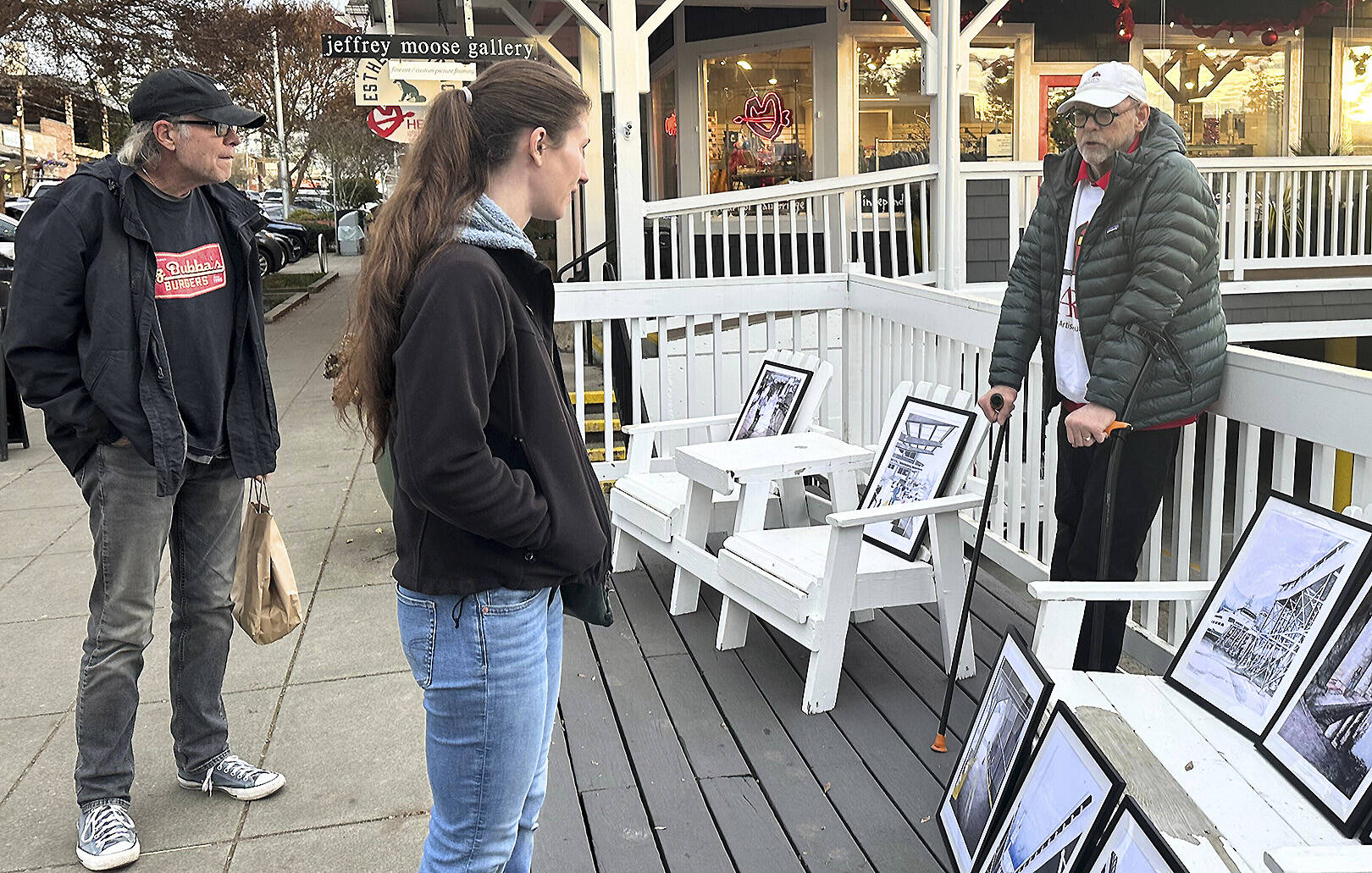 Some passers-by chat with Warren Pollock about his art.