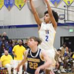 Luke Caputo/Kitsap News Group photos
With banners hanging in the background, Bremerton sophomore Aaron Matthews puts up a shot over Bainbridges Luke Johnson in a 75-42 win. The Knights talked about adding another banner to the collection with the win.