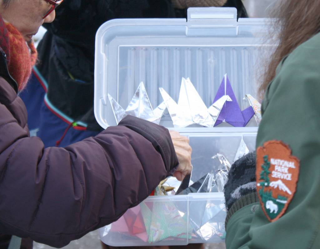 Some attendees selected paper cranes to place at the pole, courtesy of the BI Japanese American Exclusion Memorial.