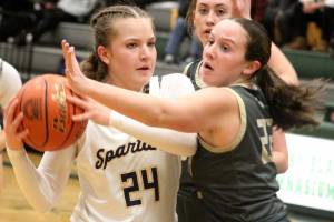 Luke Caputo/Kitsap News Group photos
Bella Ramirez of Bainbridge holds the ball as Teegan DeVries of North Kitsap plays tight defense in a 33-20 Spartan win in the semifinals of the District 3 2A girls basketball tournament Feb. 20 at Foss High School.