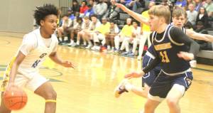 Luke Caputo/Kitsap News Group photos
Charlie Hill of Bainbridge guards Jaydon Turner of Bremerton during a district semifinal game Feb. 21 at Foss High School.