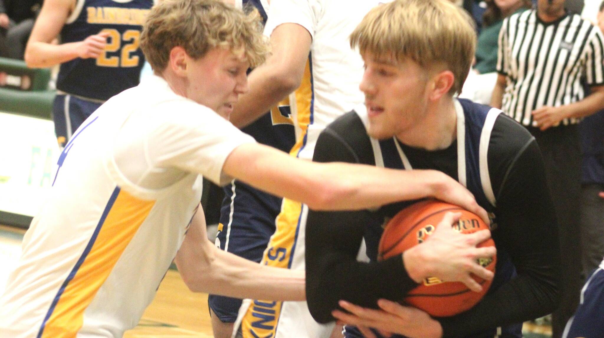Bremerton Knight Dallin Anderson wrestles for the ball with Bainbridge Spartan Charlie Hill.