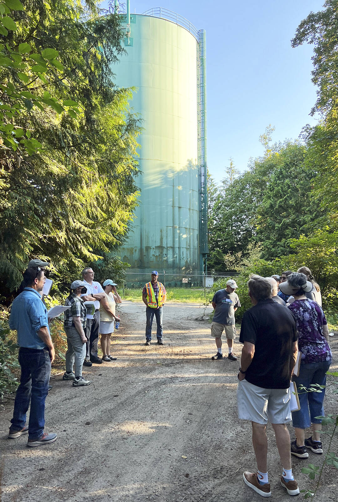 Community members learn about the citys plan to replace water Tank 2 located behind the softball field at Bainbridge High School.