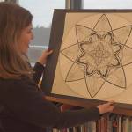 Cathy DeLorey shares former students artwork at Bainbridge High School.