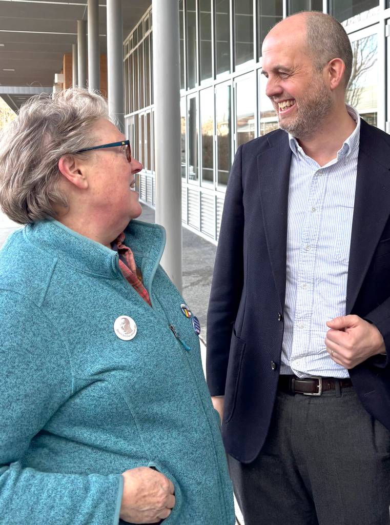 State Sen. Drew Hansen speaks with master gardener Ann Lovejoy after the Town Hall.