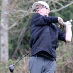 Luke Caputo/Kitsap News Group photos
Viking golfer Justin Gallant hits his ball through the rain in a 161-181 North Kitsap loss to the Bainbridge Spartans March 27 at the Wing Point Golf and Country Club on BI.