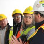 BI city manager Blair King, Mayor Ashley Mathews and Councilmember Leslie Schneider listen to LIHI senior architect Eric Blank explain the design of a three-bedroom unit.