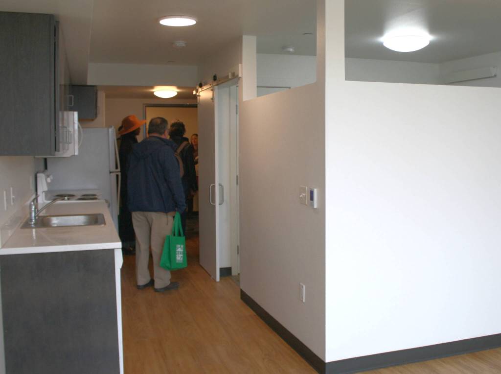 A studio unit is refreshed for a new tenant in LIHIs George Fleming Place, with a built-in dividing wall between the common space and the bedroom.