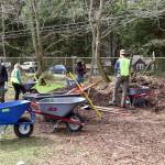 Bainbridge Island Metro Park & Recreation District employees spread mulch around trees during the Earth Day Expo at Battle Point Park in 2024.