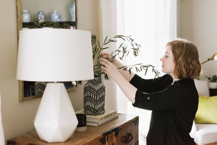 Maggie Stephens arranges some greenery in a vase for a client.