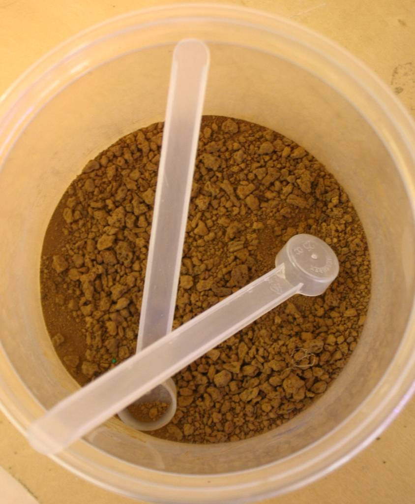 A cup of substrate that simulates regolith from the planet Mars, the loose dust and rocks that sit atop the bedrock. Soil is part of Earths regolith, but Mars has no humus or bacteria.