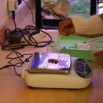 Students measure arcillite to use in a filtration experiment.