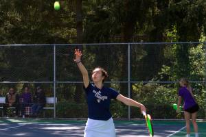 Luke Caputo/Kitsap News Group photos
Spartan Marta Llorens tosses the ball up for a serve in a 6-1, 6-2 doubles match win over North Kitsap April 30 at Bainbridge High School.