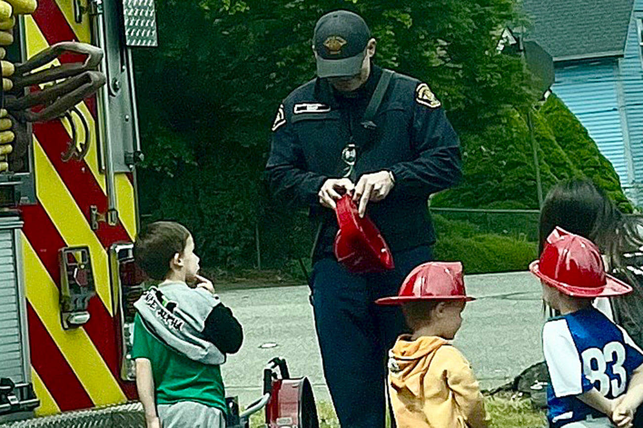 The Bremerton Fire Department passed out firefighter hats to children at the Kitsap Childrens Mobile Museum Day May 3.