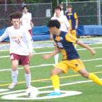 Luke Caputo/Kitsap News Group photos
Spartan Jazz Epstein dribbles the ball with Buccaneer Rocco Thompson pursuing in a 12-0 Bainbridge Senior Night win over Kingston May 2.