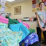 Rielly Komatsu, a member of Girl Scout Troop 41396, delivers specially-measured blankets sewn for the cats.