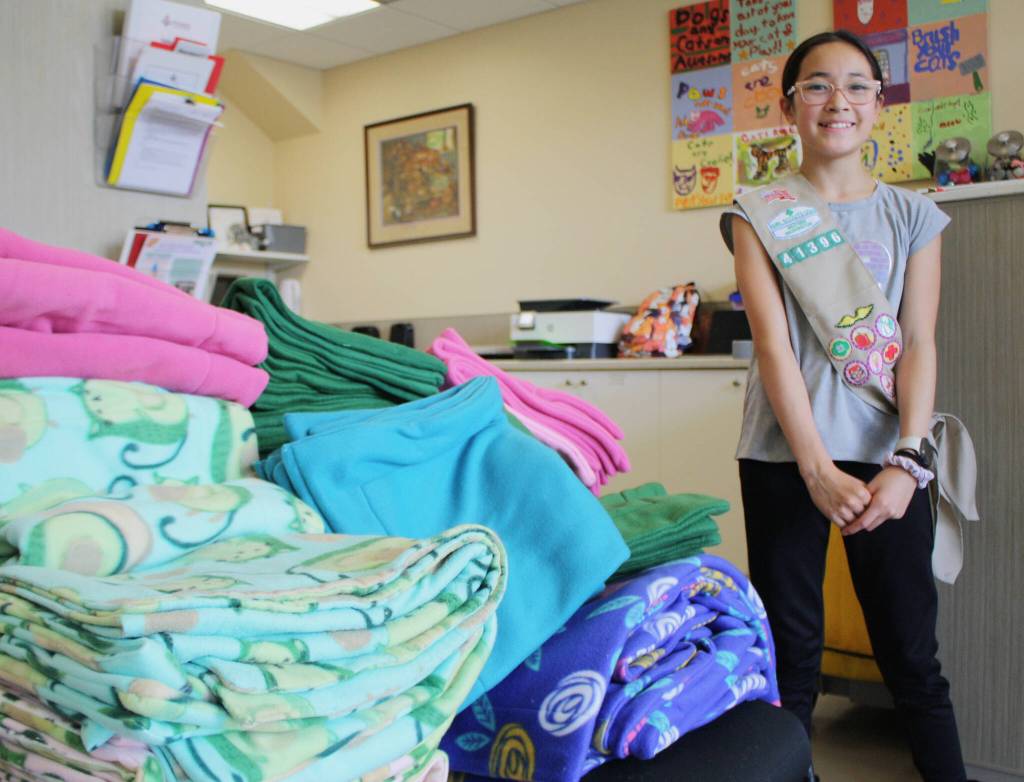 Rielly Komatsu, a member of Girl Scout Troop 41396, delivers specially-measured blankets sewn for the cats.