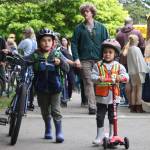Brothers Everest, left, and Aidan Sagmiller get ready to commute home on their bikes and scooters from Ordway Elementary May 16.
