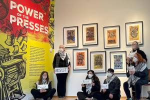 Molly Hetherwick/Kitsap News Group photos
Demonstrators silently pose in BIMAs Power of the Presses exhibit, holding signs with the word resist and wearing tape or masks over their mouths with the word censorship.