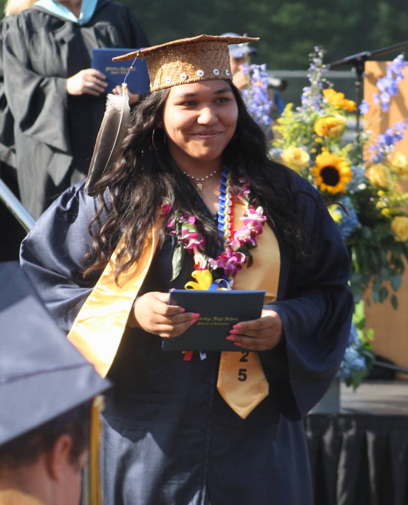 Sofia Peato smiles with her diploma.